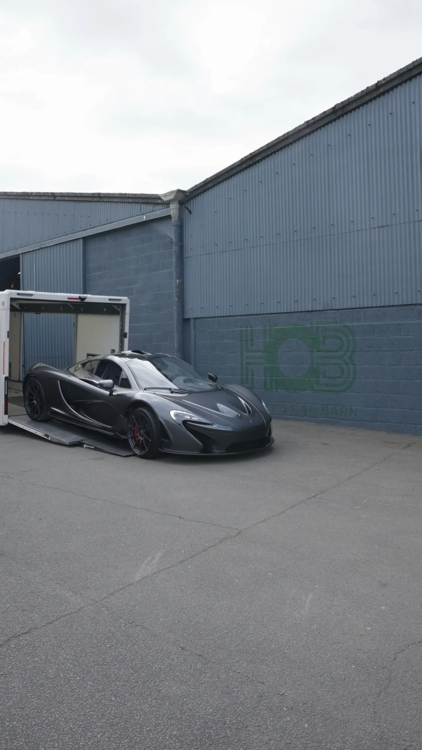 A McLaren inside an FH Transportation enclosed transporter